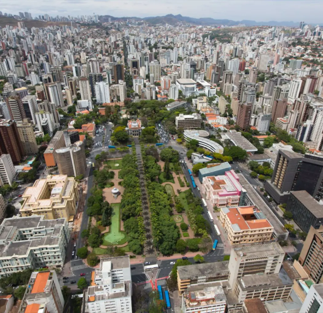 Aerial view of Florianópolis, Brazil, featuring the city's skyline, lush parks, and modern architecture, highlighting the vibrant urban environment and natural beauty.