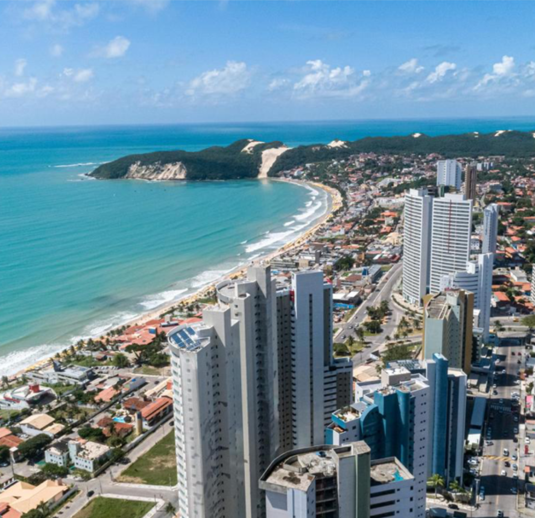 Aerial view of Natal, Brazil, showcasing the turquoise coastline, sandy beaches, and modern cityscape, highlighting the vibrant atmosphere of this coastal city.