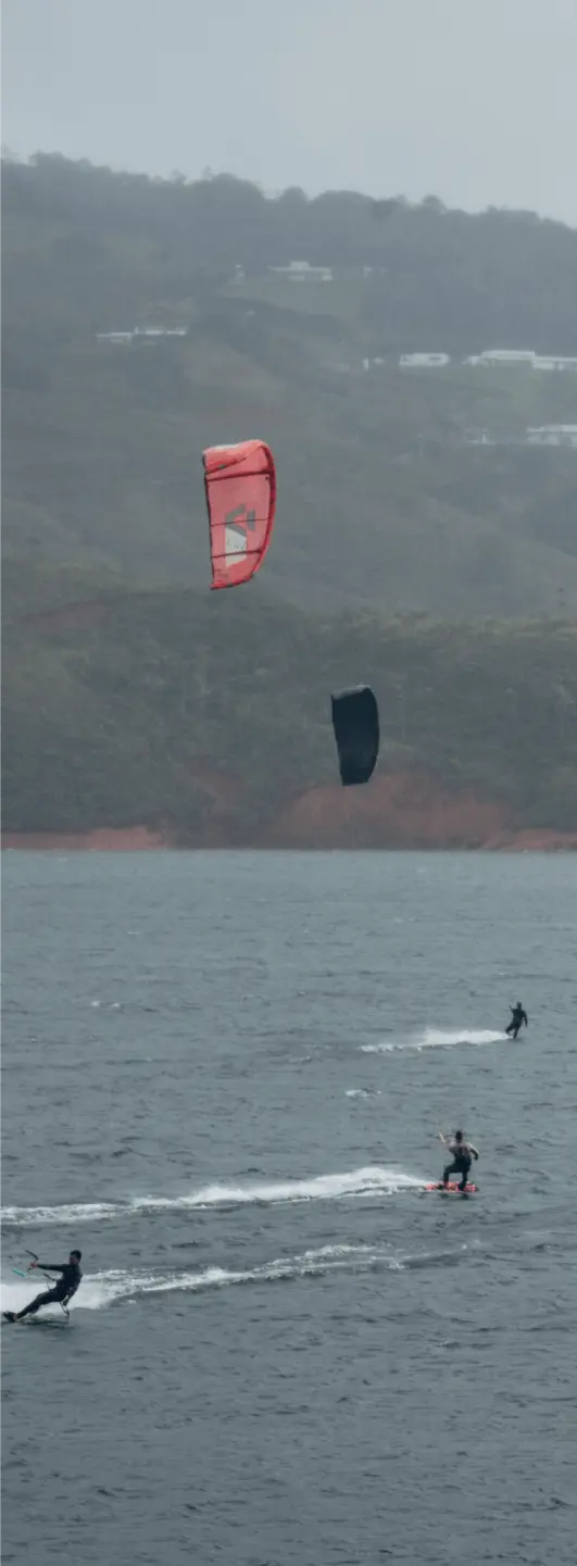 Kitesurfers enjoying the water at BJJ Camp XP, emphasizing the focus on safety during adventurous activities.