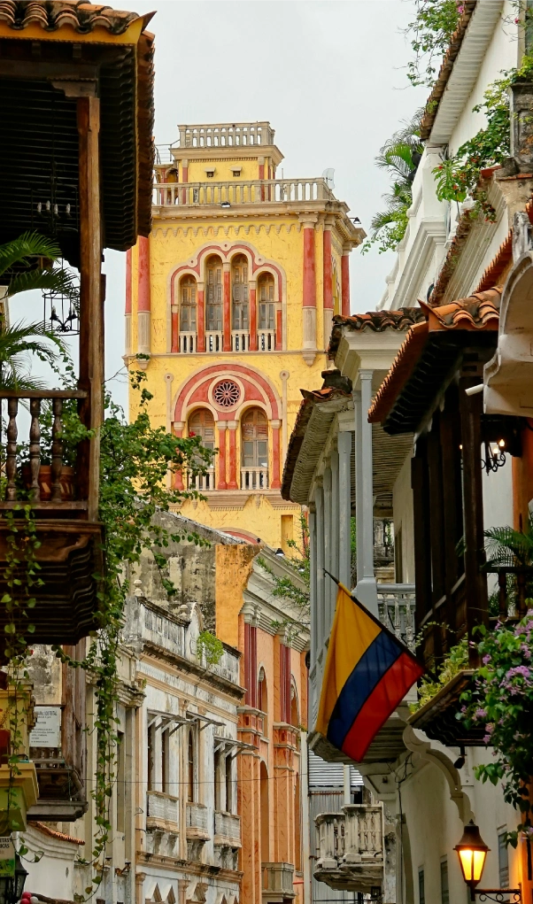 A colorful colonial tower framed by historic balconies and a Colombian flag, perfect for exploring after BJJ Camp in Colombia.