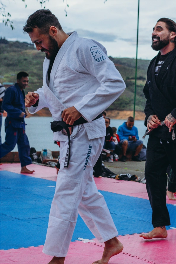 Leonidas Benjumea sharing a light moment while training in Jiu-Jitsu during a lakeside session at Calima, Colombia.