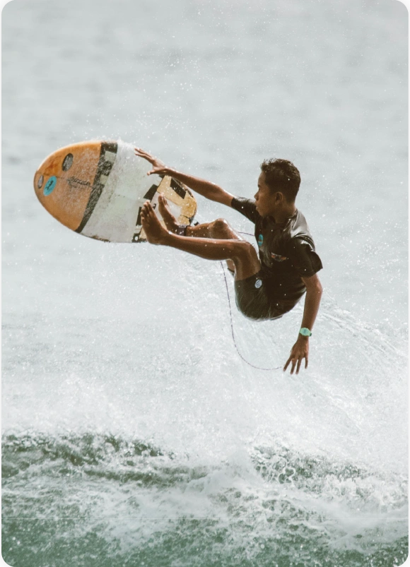 BJJ Camp Pricing.Surf & Train in Paradise BJJ Camp pricing image showing a surfer mid-air during a session included in the camp package.