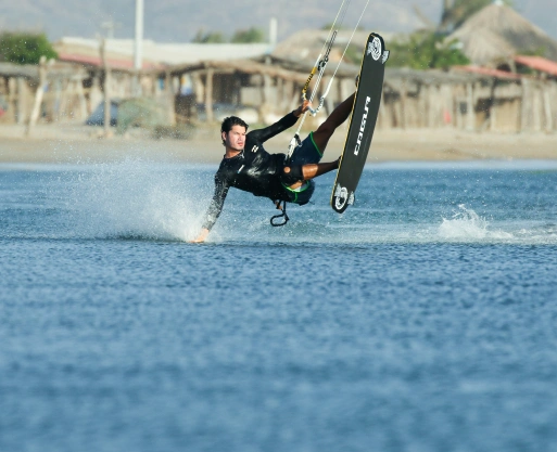 BJJ Camp Kiteboarding Thrills on Calima Lake A kiteboarder glides across Calima Lake’s waters during a BJJ Camp adventure activity.