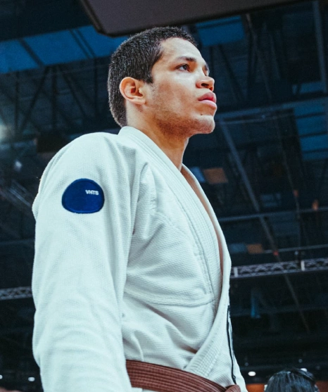 Athlete wearing white gi preparing for competition at a Brazilian Jiu Jitsu Camp in Peru.